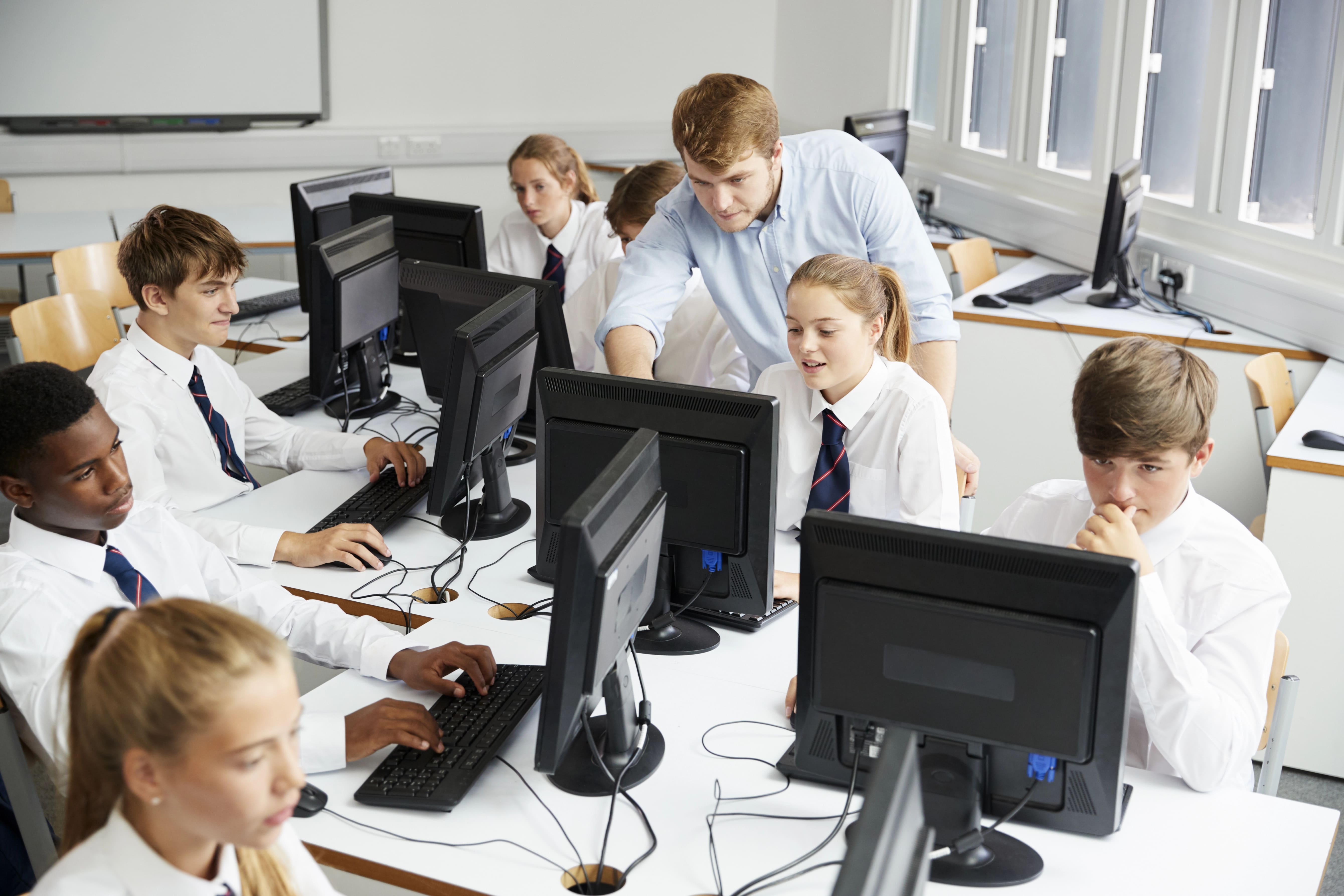 Sixth form students using computers in a school library.