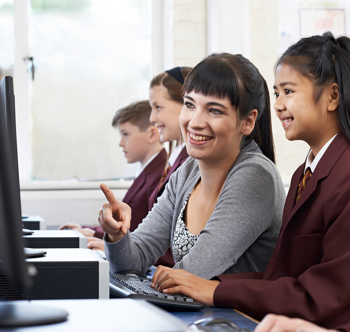 Teacher and students using a computer.