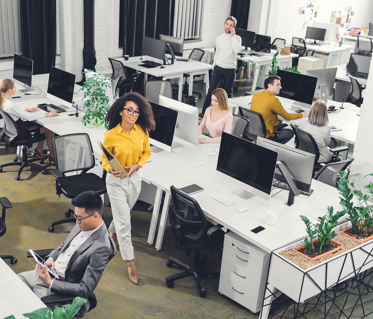 Atlas Support-Connected-flexpace-workspaces-high angle view of multiracial young business people working with computers and documents in open space 